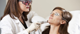 An aesthetician performs the procedure of laser resurfacing